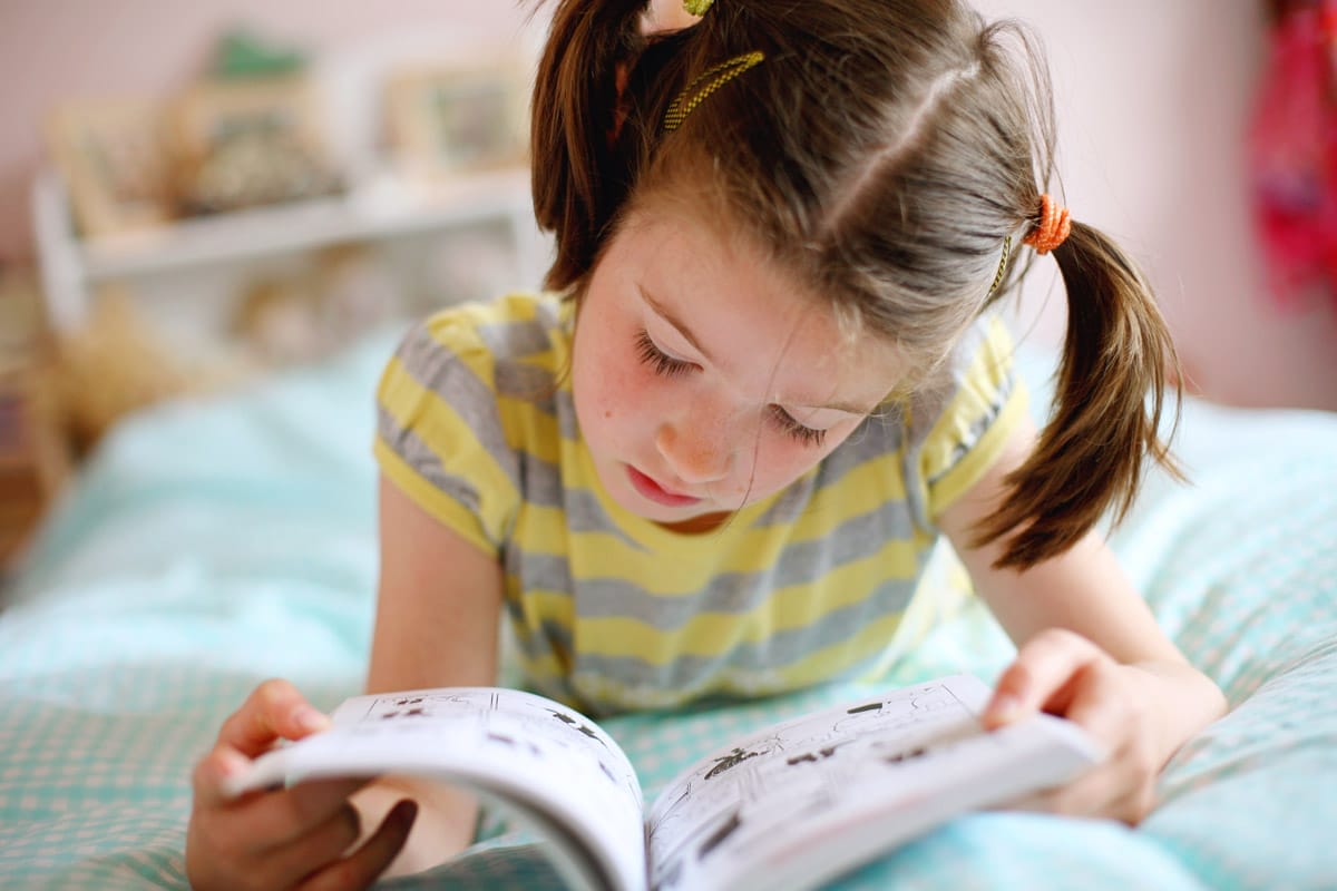 Young person reads comic book