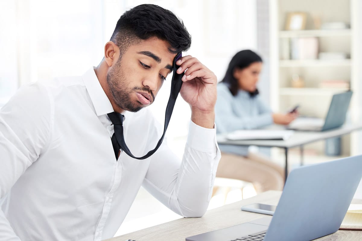 Unhappy worker at desk